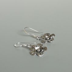 A PAIR of sterling silver flower ear danglers. Dimensions: 10 x 10 mm Drop length:22 mm Weight: 1.42 gm Price listed is for a PAIR of hoops. These earrings are made of 925 hypoallergenic sterling silver and comes with a 925 stamp. Can be packaged in a gift box. I can include a personal message from you if needed You are welcome to contact me at... bhavnakwintra1956@gmail.com For more beautiful pieces from my shop, please browse 👇 TOE RINGS: https://www.etsy.com/your/shops/TheSilverGame/tools/li Sterling Silver Flower-shaped Earrings, Silver Flower Jewelry With Matching Earrings, Silver Flower Earrings For Pierced Ears, Sterling Silver Flower Charm Earrings For Anniversary, Handmade Sterling Silver Flower Earrings, Silver Flower Earrings For Gift, Sterling Silver Flower Charm Earrings, Silver Sterling Flower Pendant Earrings, Sterling Silver Flower Earrings In White Gold