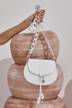 Ultra-chic mini white purse, handmade of fine quality leather. Clio design features our signature chain shoulder strap with metallic hardware. Carry this boho-style white saddle bag with you from day to evening when you only need the essentials. It comes in 4 colors: White, camel (waxed tan), black and black & white. ●Size: Height 16cm(6.3 inches) - Width 20.5(8.1 inches) - Depth 4.5cm(1.8inches) ●Detachable strap: 106cm (41.7inches) ●Magnetic snap closer ●Without lining Greek Chic Handmades boho style leather bags are delivered in a luxury box with dust bag included. Discover the whole collection with our unique leather bags: www.etsy.com/shop/GreekChicHandmades?ref=seller-platform-mcnav&section_id=15827194 Back to the shop: www.etsy.com/shop/GreekChicHandmades SHIPPING Every bag is handm Luxury Box Bag With Detachable Strap For Shopping, White Luxury Shoulder Bag With Mobile Phone Holder, White Bags With Chain Strap As Gift, Modern White Saddle Bag For Everyday Use, Chic White Leather Saddle Bag, White Leather Saddle Bag With Adjustable Strap, Trendy White Shoulder Bag With Metal Hardware, Elegant White Saddle Bag With Detachable Strap, Elegant White Rectangular Saddle Bag