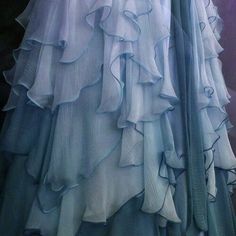 the dress is blue and white with ruffles on it's bottom layer