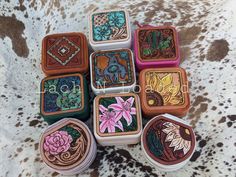 "The perfect travel size jewelry box for all the essentials. Hand tooled leather patches featuring pretty florals and classic southwest patterns.  Smooth boxes have mirror and fold out compartment, velvet have necklace pouch and hooks.  Each  Square box is 4x4x2\". Round boxes are approximately 4x3.5x2\"." Artisan Hand Tooled Jewelry, Multicolor Hand Tooled Jewelry Gift, Multicolor Hand Tooled Jewelry As Gift, Multicolor Hand Tooled Jewelry For Gifts, Necklace Pouch, Graduation Cap Toppers, Leather Jewelry Box, Travel Jewelry Case, Pink Box