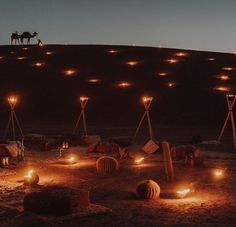 candles are lit up in the desert at night