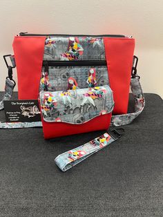 "Sally Crossbody Bag with adjustable sholder strap. Approx 11\" wide x 8\" high x 3\" deep. Front zip pocket, top zip closure.  Cotton fabric with red vinyl. Sally Mini clutch. Magnetic closure. Coin zip pocket, 8 card slots, 2 slip pockets for notes.  Key Fob included. Cotton fabric with red vinyl. Approx 4\" wide x 3\" high x 1\" deep" Retro Crossbody Shoulder Bag With Zipper Pocket, Retro Red Shoulder Bag With Removable Pouch, Red Retro Shoulder Bag With Removable Pouch, Red Satchel With Zipper Closure For School, Red Satchel Shoulder Bag With Zipper Pocket, Retro Red Shoulder Bag With Zipper Closure, Red Satchel With Zipper Pocket For Daily Use, Retro Red Bag With Removable Pouch, Red Shoulder Bag With Detachable Strap For School