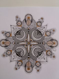 a drawing of an intricate design on a white background with black and gold accents,