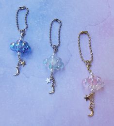 three key chains with charms attached to them