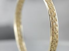 This is such a pretty and classic piece! The texture of the woven center gives the bangle a rich, luxurious profile. It will work great as a stacking bracelet, and is still beautiful all on its own. The condition is fantastic, and the design is light and airy but still substantial with strong, structural lines. Metal: 14K Yellow Gold Width: 6.4 mm Inside Circumference: 7 inches Marks: "14K" Stamped on the clasp Filigree Bangle, Vintage Gold Bracelet, Pearl Bangle Bracelet, Gold Link Necklace, Marquise Shape Diamond, Vintage Rose Gold, Gold Link Bracelet, Pearl Bangle, Bracelets Gold Diamond