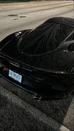 a black sports car parked on the side of the road