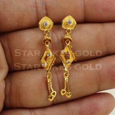 Elevate your style with these beautifully handcrafted gold earrings. Featuring a classic design and a comfortable fit, they add a refined touch to any look. Ideal for everyday wear or special occasions, they bring a subtle yet sophisticated sparkle. 18K Gold Dangle Earrings Metal is Real Gold Purity is 18kt Weight is 2.74 grams approx Max Length is 4.1 cm approx Max width is 0.7 cm approx ,  these earrings comes with normal backs, if you want real gold screw please contact. Please feel free to a Classic 22k Gold Earrings, Classic Gold Diamond Drop Earrings, Simple Design 14k Gold Earrings, Dainty Yellow Gold-plated Earrings, 14k Gold Classic Diamond Earrings With Elegant Design, Classic 14k Gold Diamond Earrings With Elegant Design, Dainty Yellow Gold Plated Earrings, Classic Gold Earrings With Elegant Design, 22k Gold Fine Jewelry Earrings For Formal Occasions