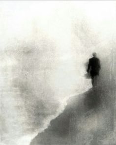 a blurry image of a person standing on top of a hill in the fog