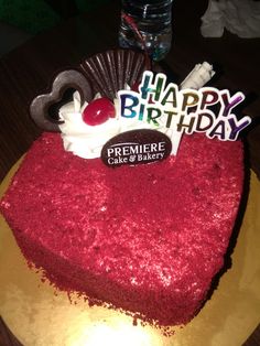 a heart shaped cake with the words happy birthday written on it and a candy bar in the shape of a heart