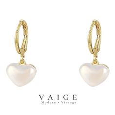 VAIGE Pearl Heart Huggie Hoop Gold Earrings Embrace a blend of elegance and modern charm with the VAIGE Pearl Heart Huggie Hoop Gold Earrings. These exquisite earrings are designed to celebrate your unique style while adding a touch of sophistication to any ensemble. High-Quality Materials: Crafted from premium Copper Alloy, ensuring durability and a luxurious finish. Charming Design: Featuring a stunning heart shape that elegantly measures 2.4cm by 1cm, perfect for showcasing your romantic side Elegant Hoop Heart Charm Earrings, Elegant Small Hoop Earrings For Valentine's Day, Elegant Heart Charm Huggie Earrings For Valentine's Day, Elegant Dangle Huggie Earrings For Valentine's Day, White Dangle Hoop Earrings For Valentine's Day, White Huggie Earrings For Valentine's Day, Hoop Gold Earrings, Vintage Inspired Earrings, Open Hoop Earrings