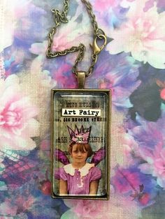 The ArT Fairy  The art fairy necklace  is for the artist in your life , this whimsical fairy makes a great pendant .This necklace is made of brass and is encased in glass, the pendant measures 1x2 inches. The antiqued brass chain measures 24 inches. * FIND SEVERAL OTHER FAIRY PENDANTS IN THIS SHOP , THERE ARE MANY TO CHOOSE FROM ++ Handmade Fairy Grunge Necklace For Gift, Fairy Grunge Handmade Necklace Gift, Handmade Fairy Grunge Necklaces As Gift, Handmade Fairy Grunge Necklaces For Gifts, Domino Pendant, Whimsical Necklace, Artist Jewelry, Necklace Fairy, Fairy Pendant