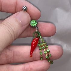 Chili Pepper Dangle Belly Ring. 316-L Surgical Steel Belly Rings. 14 Gauge Belly Rings. The Chili Pepper Is Glass; The Dangles Have Rhinestones In Them. I Did Not Include A Split Ring On This As It Would Have Broken The Glass. This Belly Ring Features A Green Gem On The Belly Ring. I Do Not Recommend Sleeping Or Showering In This Belly Ring Due To The Glass Charm. Red Metal Body Jewelry For Gift, Red Metal Body Jewelry As A Gift, Adjustable Green Belly Rings As Gift, Braid Clips, Dangle Belly Rings, Green Gem, Star Charm Necklace, Faux Pearl Bracelet, Oval Stud Earrings