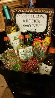 an assortment of liquors and condiments in a black box on the counter