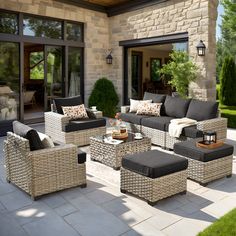 an outdoor living room with wicker furniture