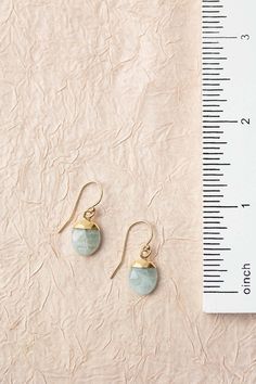 Perfect in their simplicity, these aquamarine bezels are set in gold and dangle from gold filled earwires. Gold Filled (nickel and lead-safe) Aquamarine .75", with gold filled earwires We hand select our natural materials, thus there may be slight variations in color and/or size that will not detract from the overall aesthetic Our unique handcrafted designer jewelry for women is made in America, each design created individually in our personal design studio in Floyd VA USA