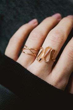 The elegant curves of this design are wave-like, creating a sense of movement and fluidity that is versatile and organic. The ring is handcrafted out of a D-shaped (half round) wire that is then flattened and formed into this three dimensional form. This listing is for ONE single ring in 14K Rose Gold Fill The thickness of the metal used with this ring measures approximately 2mm which gives this piece a durable and sturdy design while maintaining that effortless look. While this ring is gorgeous Gold Bypass Ring With Modern Twist, Elegant Spiral Bypass Ring, Minimalist 14k Gold Wire Wrapped Rings, Elegant Gold Spiral Stackable Rings, Elegant 14k Gold Spiral Rings, Rose Gold Stackable Rings With Modern Twist, Rose Gold Stackable Open Rings With A Modern Twist, Adjustable Wavy Rings With A Modern Twist, Delicate Open Band Midi Ring In Rose Gold