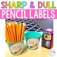 sharp and dull pencil labels are displayed in two buckets on a table next to a camera