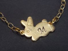 This is a very cute gold plated INITIAL bunny necklace. This cute brass bunny pendant is suspended on a gold cable chain. This necklace secures in the back with a lobster clasp. Perfect for everyday wear. Necklace is approximately 17 inches in length. Tiny bunny pendant: 16mm*12mm MATCHING BRACELET ALSO AVAILABLE ALSO AVAILABLE IS SILVER Visit my shop at http://www.etsy.com/shop/mlejewelry All jewelry will be packaged in a gift box. If you have multiple items and need each in their own gift box, Cute Personalized Gold Charm Necklace, Cute Handmade Gold Charm Necklaces, Handmade Cute Gold Charm Necklaces, Cute Handmade Gold Necklaces, Cute Gold Necklace With Lobster Clasp, Cute Gold Pendant Charm Necklaces, Cute Gold Pendant Charm Necklace, Cute Gold Pendant Necklace, Cute Gold Necklace With Adjustable Chain