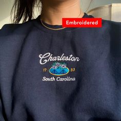 "*SIZES ARE UNISEX* -I'd suggest your usual size for a more fitted look, or sizing up for a more relaxed fit. *these sweatshirts are extra comfy when oversized \"Charleston South Carolina 1783\" embroidered on a cute vintage-style crewneck. A cozy sweatshirt bound to keep you warm in the colder months. A pre-shrunk, classic fit sweater that's made with air-jet spun yarn for a soft feel and reduced pilling. Your new favorite sweatshirt! * 50% cotton, 50% polyester * Pre-shrunk * Classic fit with no center crease * 1x1 athletic rib knit collar with spandex * Air-jet spun yarn with a soft feel and reduced pilling * Double-needle stitched collar, shoulders, armholes, cuffs, and hem * Gildan 18000 Unisex Heavyblend Sweatshirt Please note that the embroidery comes with a backing that acts as a s South Carolina Sweatshirt, Crew Neck T-shirt With Custom Embroidery, Embroidered Relaxed Fit College T-shirt, Casual Tops With Custom Embroidery For College, Custom Embroidery Crew T-shirt For College, Custom Embroidered Crew T-shirt For College, College Crew T-shirt With Custom Embroidery, Custom Embroidery Crew Neck T-shirt For College, Relaxed Fit Crew T-shirt With Custom Embroidery