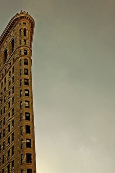 a tall building with lots of windows on it's side and sky in the background