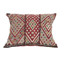 two red and white decorative pillows on a white background