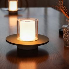 a lit candle sitting on top of a wooden table