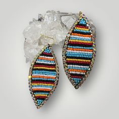 Serape Rhinestone Beaded Earrings  Beaded in bright colors to brighten up any outfit. Handmade with seed glass beads and to give it a dramatic look with the contrast of the colors and the rhinestones adds just the right Dazzle to your outfit. The brights colors brings out the design in these beautiful earrings! 3" drop  1.5" wide 32 rows of hand sewn seed Beads to create the Serape  signature look. Festival Multicolor Rhinestone Jewelry, Multicolor Rhinestone Festival Jewelry, Multicolor Rhinestone Jewelry For Festivals, Multicolor Rhinestones Jewelry For Festival, Multicolor Faceted Beaded Earrings For Festivals, Earrings Beaded, Dramatic Look, Earrings 3, Signature Look