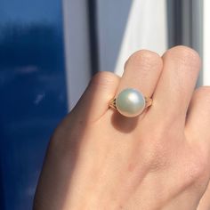 Two-tone 14KT white gold + yellow gold band ring with genuine, cultured Paspaley South Sea Pearl. Choose your finger size Contact us for additional sizes 12mm Paspaley Pearl; "Fine" quality; "Circle" shape Paspaley Certificate of Authenticity included Weight: 6.31g Made to order: please allow 7-10 business days prior to shipping Pearl will vary slightly from photos Classic Hallmarked Opal Ring Round Cut, White Dome Ring Fine Jewelry, Classic Dome Ring With Gemstone Round Cut, Yellow Gold Opal Ring With Prong Setting, Classic White Opal Ring With Round Band, Fine Jewelry Dome Ring With Solitaire, Timeless Round Moonstone Ring For Anniversary, White Round Dome Ring For Anniversary, Timeless White Pearl Ring