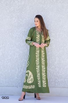 **Note : The kaftan in the video is a different color of the exact same Kaftan and is only displayed to show the fit, flow, and cut of the Kaftan. You will receive the one in the pictures.** Ideal for shorter women, this bohemian embroidered dress is a an eye catcher ! It is an extremely comfortable wear, light and soft and can be used on many occasions -  home gatherings, festival parties, summer occasions, dinners, or just in your home to feel comfortable.  Fabric : 70% Egyptian Cotton; 30% Po Long Cotton Dresses For Eid, Spring V-neck Kaftan With Chikankari Embroidery, Folk Style Chikankari Embroidery Dress For Eid, Green Embroidered Floor-length Maxi Dress, Embroidered Green Floor-length Maxi Dress, Bohemian Maxi Kurta For Eid, Bohemian Style Maxi Length Kurta For Eid, Bohemian Maxi Length Kurta For Eid, Cotton Maxi Dress With Resham Embroidery