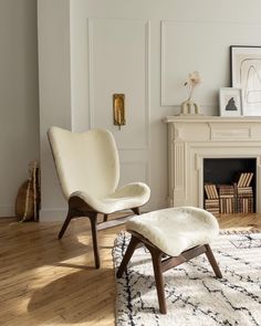 a white chair and ottoman in a living room