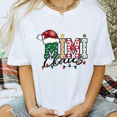 Our handmade Mimi Claus t-shirts are crafted from the highest quality materials for an ultra-soft and comfortable wear. Our trendy Mimi Claus shirts ship the same or next business day and are printed using an eco friendly water based ink that is not only safe for you but also safe for the environment! 💖  Bold and Bloom Co. offers trendy items for any occasion! Our shirts are crafted from the highest quality materials for ultra-soft and comfortable wear. Most importantly, all of our items are printed using the most advanced apparel printer to ensure vibrant colors and detailed graphics.  📝 PRODUCT DETAILS  - The sleeves are rolled up for display purposes only. -Here's what it says for the materials Materials:  Unisex Short Sleeve fabric:  white, black, natural tshirts are all 100% cotton! White Christmas T-shirt Gift, White Holiday T-shirt Gift, White T-shirt For Holiday Gift, White Holiday Gift T-shirt, White T-shirt As Holiday Gift, White Letter Print Shirt For Holiday, Mimi Claus, Trendy Items, Comfort Colors Tshirt