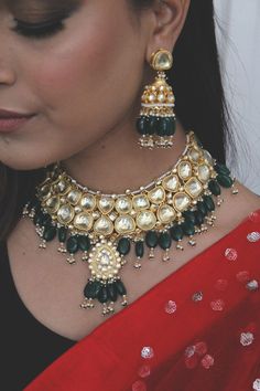 Emerald Green Gold Plated Kundan Polki Bridal Indian Choker Necklace Set with Jhumka Earrings embellished with Green Stones and Shell Pearls inspired by Sabyasachi jewellery style. Faux glass polki and shell pearls embellished Gold Plated Kundan Polki Bridal Indian Choker Necklace Set with Chandbali Earrings highlighted with red onyx tumble stones. Indian jewellery set, Indian Choker necklace set, Indian bridal jewellery, Indian wedding jewellery. Indian Necklace Set with Chandbali earrings, Ear Diwali Designer Jewelry With Latkans, Festive Designer Jewelry With Latkans, Designer Wear Festival Chandbalis, Designer Stone Work Jhumkas For Festive Occasions, Traditional Kundan Temple Necklace For Designer Wear, Designer Chandbalis For Diwali, Designer Gold Jhumkas With Latkans, Designer Kundan Necklace With Latkans, Designer Temple Jewelry Chandbalis For Diwali