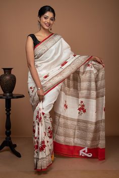 The beauty of this saree lies in its colours. It is undoubtedly the most stunning red and white pure silk saree. We've taken inspiration from nature to design this saree. The floral pattern ensures that the feel of nature stays with this saree. The red and white combination adds a sense of royalty to this saree. The touch of golden kashish complements the red colour. Kashish colour highlights the flower, thus the celebration of nature. You can drape floral print silk sarees as your party wear or wedding wear. This saree also goes well with the festivals. It is also the perfect attire for any daytime affair.  Nature inspired saree This handwoven mulberry pure silk saree has been procured without using any machines. We have a group of skilled artisans who handcrafted the entire saree. To pri White And Red Silk Saree, Saree Red Colour, Silk Saree Red, Red Silk Saree, Colour Highlights, Saree Red, Blouse Silk, Red Floral Print, Party Kleidung