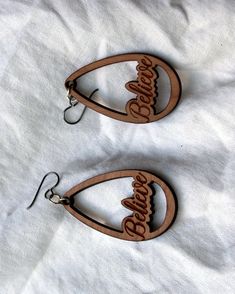 "Beautiful BELIEVE earring set with high quality niobium (anti-allergenic) ear wires. The drop earrings feature the word believe spelled out in cursive. They are cut from 1/8 inch thick renewable cherry wood. The earrings are incredibly lightweight. They hang approximately 2.75\" down and are 1.25\" wide and will last many repeated wearing." Brown Teardrop Hoop Earrings As Gift, Brown Teardrop Hoop Earrings For Gifting, Brown Teardrop Hoop Earrings For Gift, Minimal Rustic, Earthy Jewelry, Earrings Wooden, Earrings Teardrop, In Cursive, Wooden Christmas