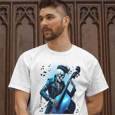 This Psychobilly Musician T-Shirt features a vibrant design of a rock and roll skeleton bassist. Perfect for those who love Rockabilly-Psychobilly rock and unique graphic tees, this shirt makes a great gift for music lovers. The detailed skull art adds a touch of edgy style to any wardrobe. Whether for a concert, a casual outing, or as a standout piece, this t-shirt is sure to impress. Product Features: Fabrication: 100% Airlume combed and ring-spun cotton, 32 single 4.2 oz. (Ash - 99% Airlume c Skull Screen Print T-shirt For Concerts, Punk Skull T-shirt For Summer, Summer Punk Skull T-shirt, Summer Punk T-shirt With Skull Design, Rock And Roll Short Sleeve T-shirt For Concert, Band Merch Skull T-shirt For Summer, Rock And Roll Band Logo T-shirt For Music Festivals, Halloween Concert T-shirt With Screen Print, Halloween Rocker T-shirt For Concerts