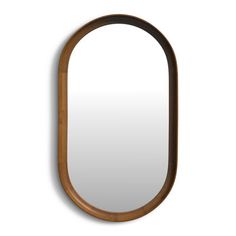 an oval wooden mirror hanging on the wall with a long curved wood frame around it