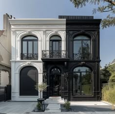 a large black and white house with lots of windows