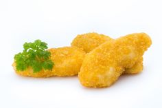 two fried chicken nuggets with parsley on top, against a white background