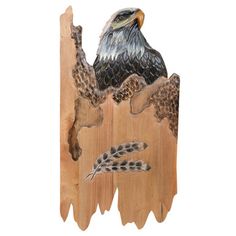 an eagle sitting on top of a piece of wood