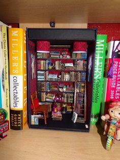 a book shelf filled with lots of books next to stuffed animals and other toy figurines