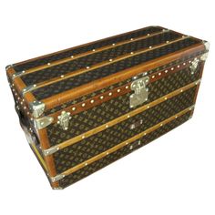 an old trunk with studs and wooden handles