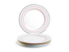 three plates stacked on top of each other with polka dot designs and pink rims