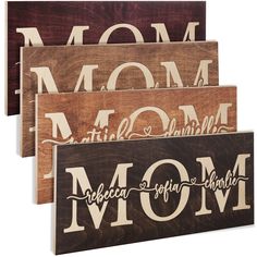 three wooden signs that say mom, bebeca, and smile