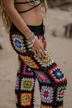 These boho essential pants in a granny square design, add effortless edge to any look. Specs: Handmade with love High rise ONE SIZE Elasticated waist Material: Polyester, Acrylic Black Hippie Beach Bottoms, Bohemian Black Pants For Beach, Black Bohemian Beach Pants, Bohemian Black Beach Pants, Colorful Bohemian Summer Pants, Multicolor Bottoms With Elastic Waistband For Festival, Multicolor Festival Bottoms With Elastic Waistband, Colorful Bohemian Beach Bottoms, Bohemian Multicolor Harem Pants For Beach