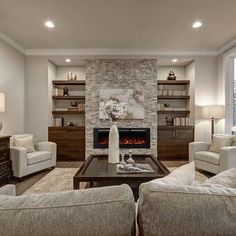 a living room filled with furniture and a fire place in the middle of a room