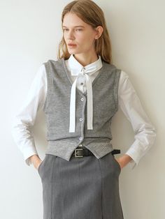 Slim-fit rib-knit wool blend sweater vest. V-neck and buttons at front. Ribbing at neckline, armholes, and hem.- Regular length- Slim fit- V-neck V-neck Knit Vest For Work, Fall Workwear Sweater Vest With Buttons, Gray V-neck Vest For Workwear, Gray Fitted V-neck Sweater Vest, Elegant Winter Workwear Sweater Vest, Fall Workwear Cardigan Vest, Elegant Sweater Vest For Workwear In Fall, Elegant Fall Sweater Vest With Buttons, Fitted Gray Sweater Vest For Fall