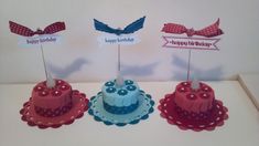 three small birthday cakes on top of each other