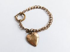 Beautiful ornate double loop effect curb chain link ladies love bracelet, in gilt brass, featuring an ornate heart charm and large oversized spring ring clasp. embossed with a 4 leaf 'lucky' clover. Unsigned, no markings. A traditional piece of Victorian era jewellery, which would make a lovely small gift for her. Circa late 1800s-early 1900s.  Measures approx 16.5 x 0.6cm open length. Designed for smaller wrists.  CONDITION: (Zoom in photos) Used antique - very good, clasp tested and works fine Antique Bronze Jewelry For Valentine's Day, Antique Brass Jewelry With Heart Charm, Vintage Gold Bracelets For Valentine's Day, Antique Brass Jewelry For Valentine's Day, Valentine's Day Brass Jewelry With Antique Finish, Vintage Gold Charm Bracelet With Heart Charm, Vintage Bracelet Jewelry For Valentine's Day, Victorian Brass Jewelry For Valentine's Day, Vintage Metal Charm Bracelet For Valentine's Day