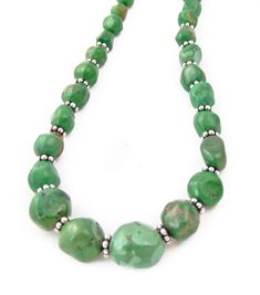 This Navajo necklace is a classic Native American accessory that you've been searching for. It is handcrafted with beautiful vivid green Turquoise stones. This is that chic accessory that will enhance your casual or dressy wardrobe. Measures: 18" toggle closureBeads vary from 1/4" to 1/2" (center)Weight: 41 grams Southwestern Green Single Strand Turquoise Necklace, Southwestern Green Turquoise Necklace With Round Beads, Southwestern Single Strand Green Turquoise Necklace, Artisan Green Turquoise Single Strand Necklace, Green Bohemian Single Strand Turquoise Necklace, Adjustable Southwestern Green Turquoise Necklace, Southwestern Green Jewelry With Large Beads, Green Turquoise Necklace With Natural Round Beads, Southwestern Green Turquoise Necklace With Gemstone Beads