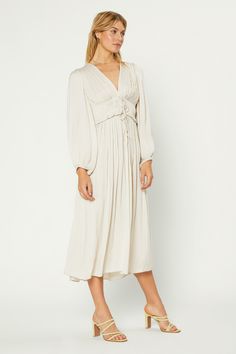 An ethereal long-sleeve dress fit for a modern goddess. With a plunging neckline and delicate pleated top that ties at the center, it's truly a stunner. •On average, customers say it fits large •Adjustable ties •Plunge neckline •Long sleeves with elastic •Midi length DIMENSIONS •Standard: 50.5" L Item number 1990150 100% Polyester Hand Wash Cold Long Sleeve Pleated Cream Dress, Cream Pleated V-neck Dress, Beige Pleated V-neck Midi Dress, Luxury Long-sleeved Pleated Dress, Luxury Pleated V-neck Midi Dress, Pleat Top, Pleated Midi Dress, Plunging Neckline, Midi Length